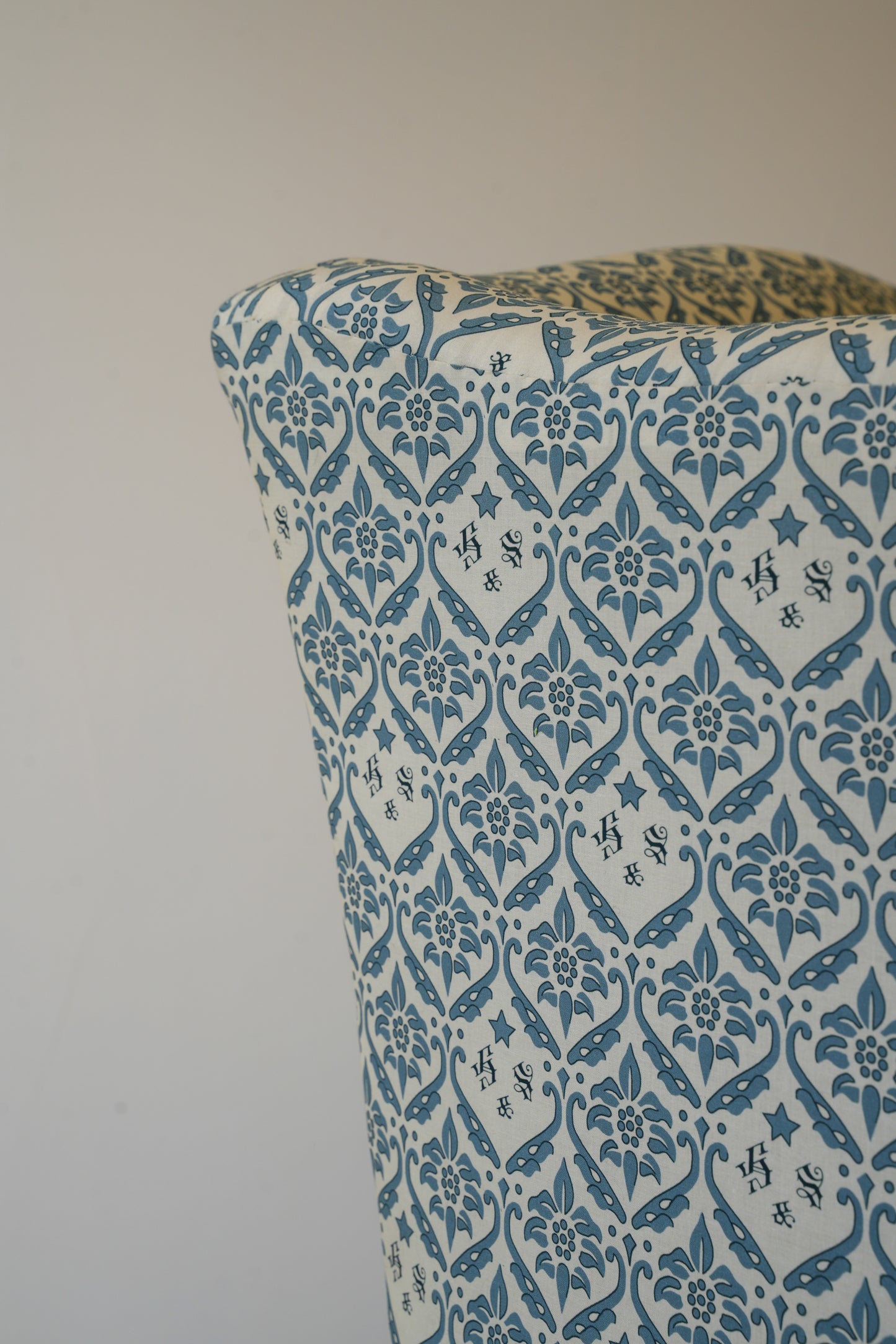 A Howard & Sons Wingback Armchair.