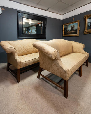 A matched pair of antique Camel back sofas