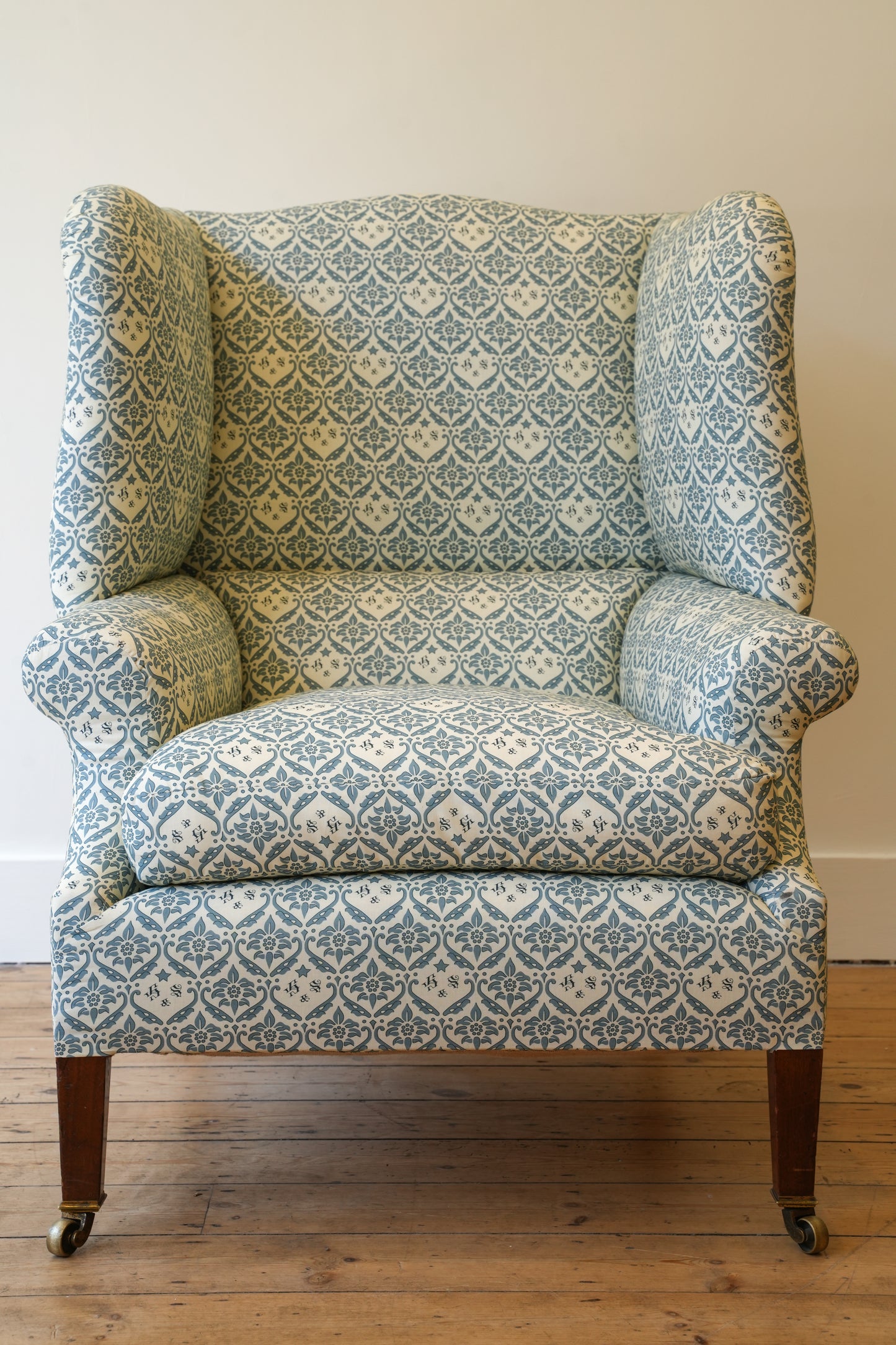 A Howard & Sons Wingback Armchair.