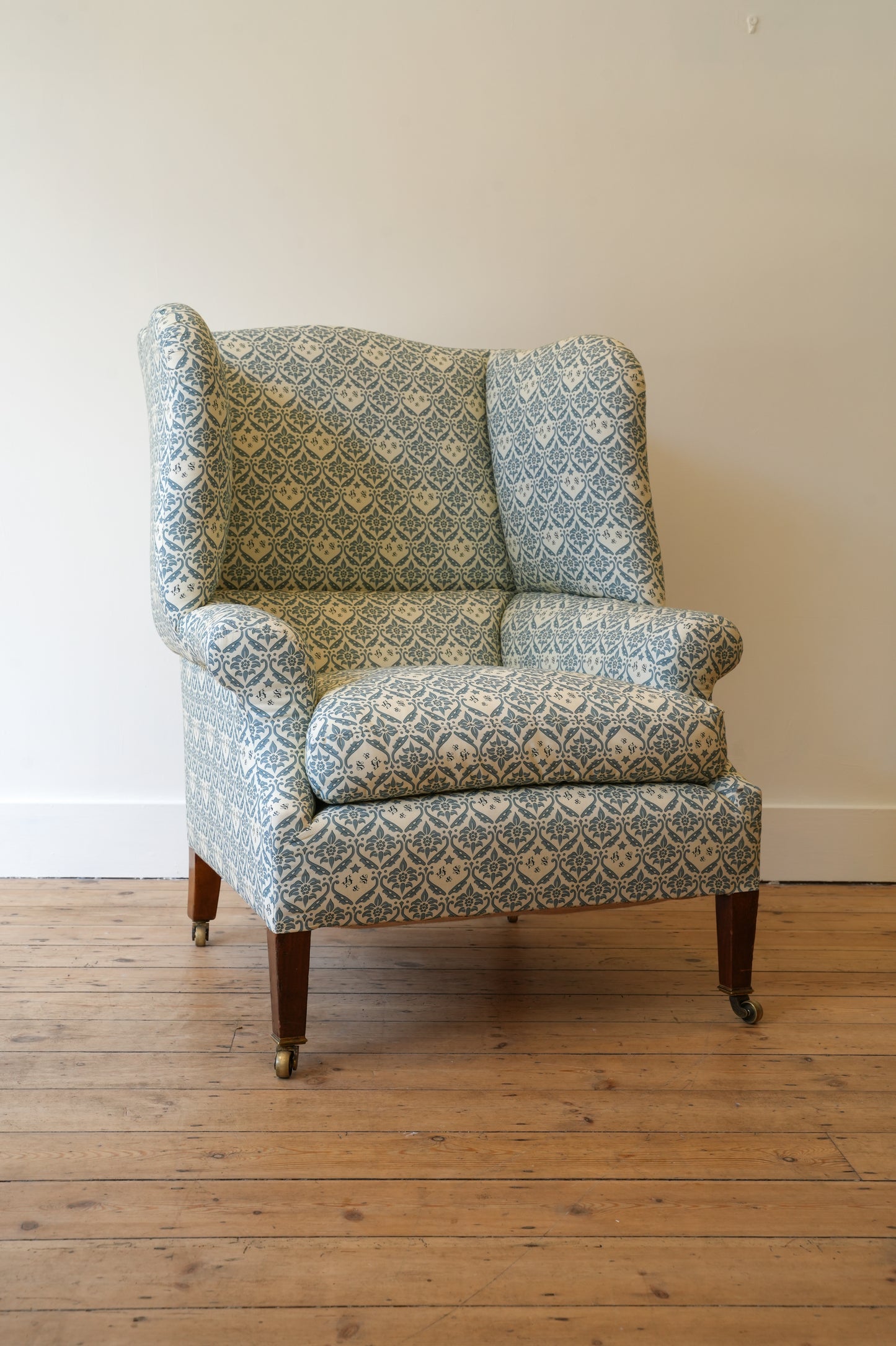 A Howard & Sons Wingback Armchair.
