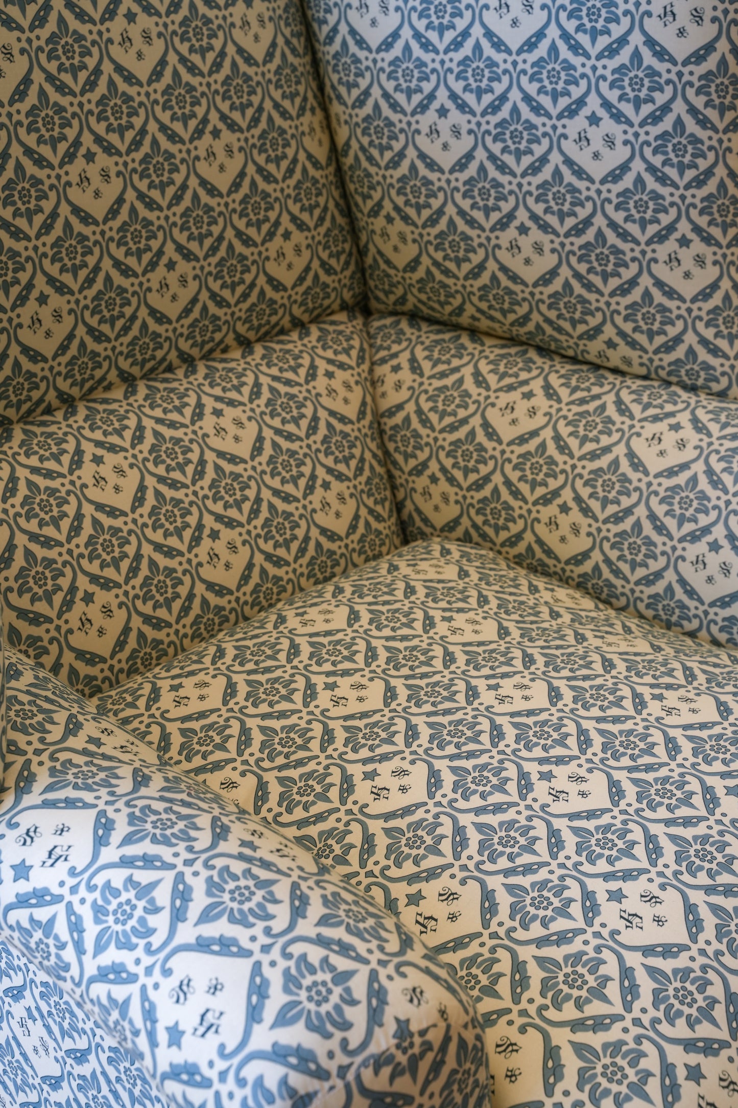 A Howard & Sons Wingback Armchair.