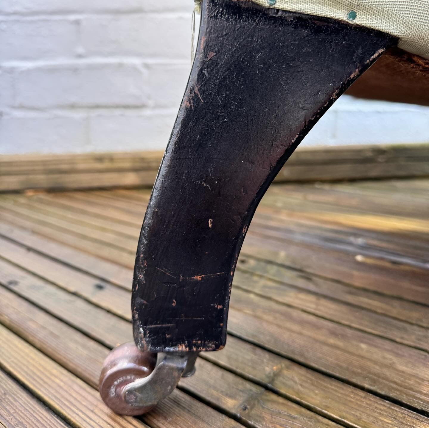 A late 19th century scrolled back slipper chair