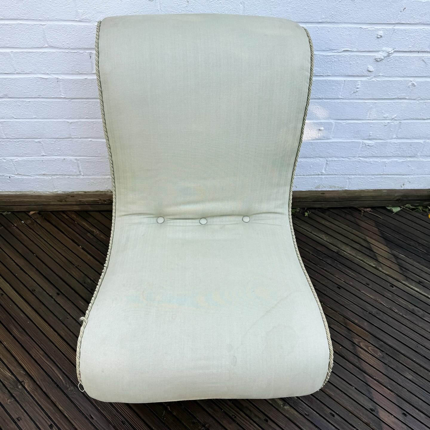 A late 19th century scrolled back slipper chair