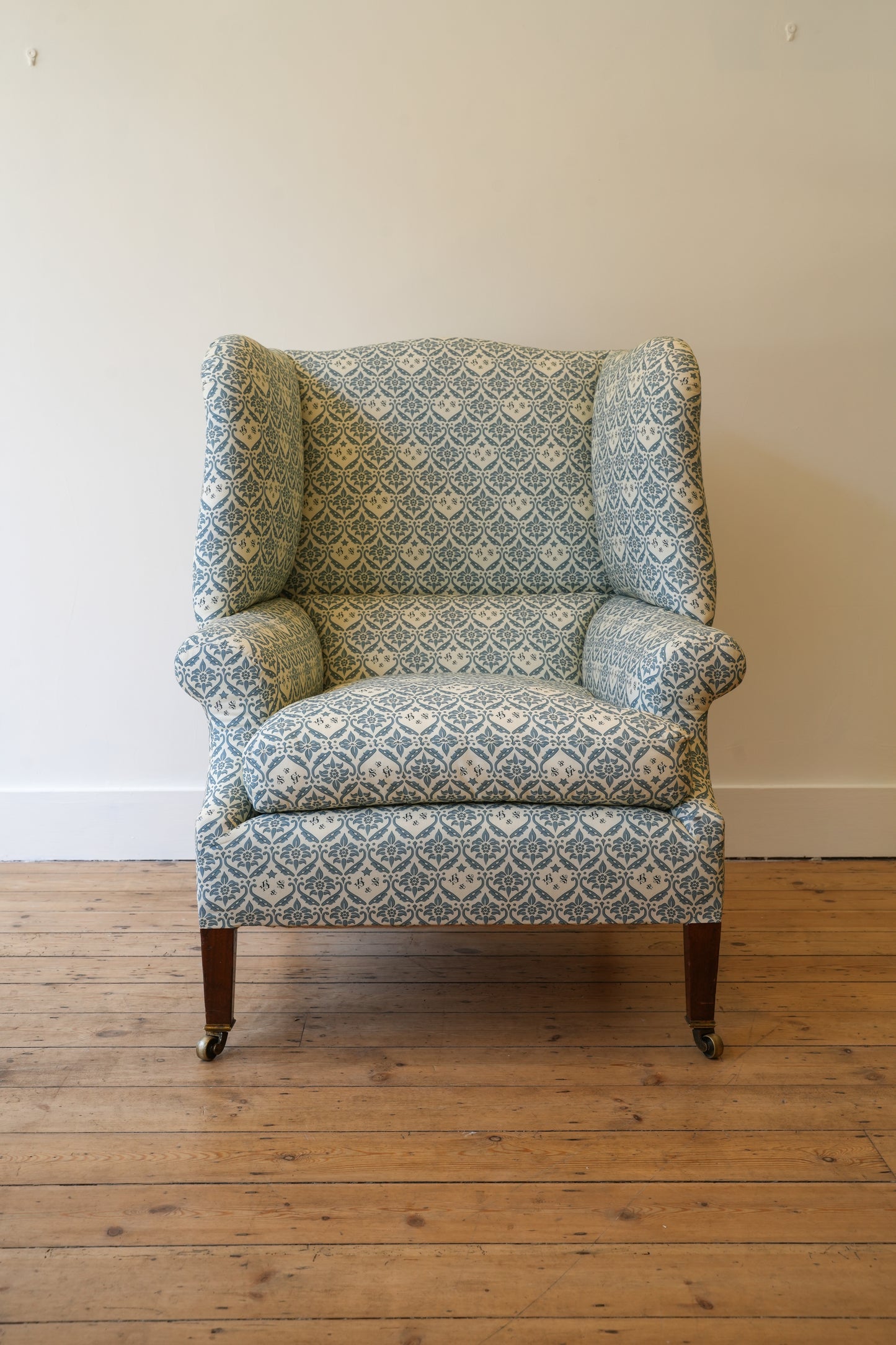 A Howard & Sons Wingback Armchair.