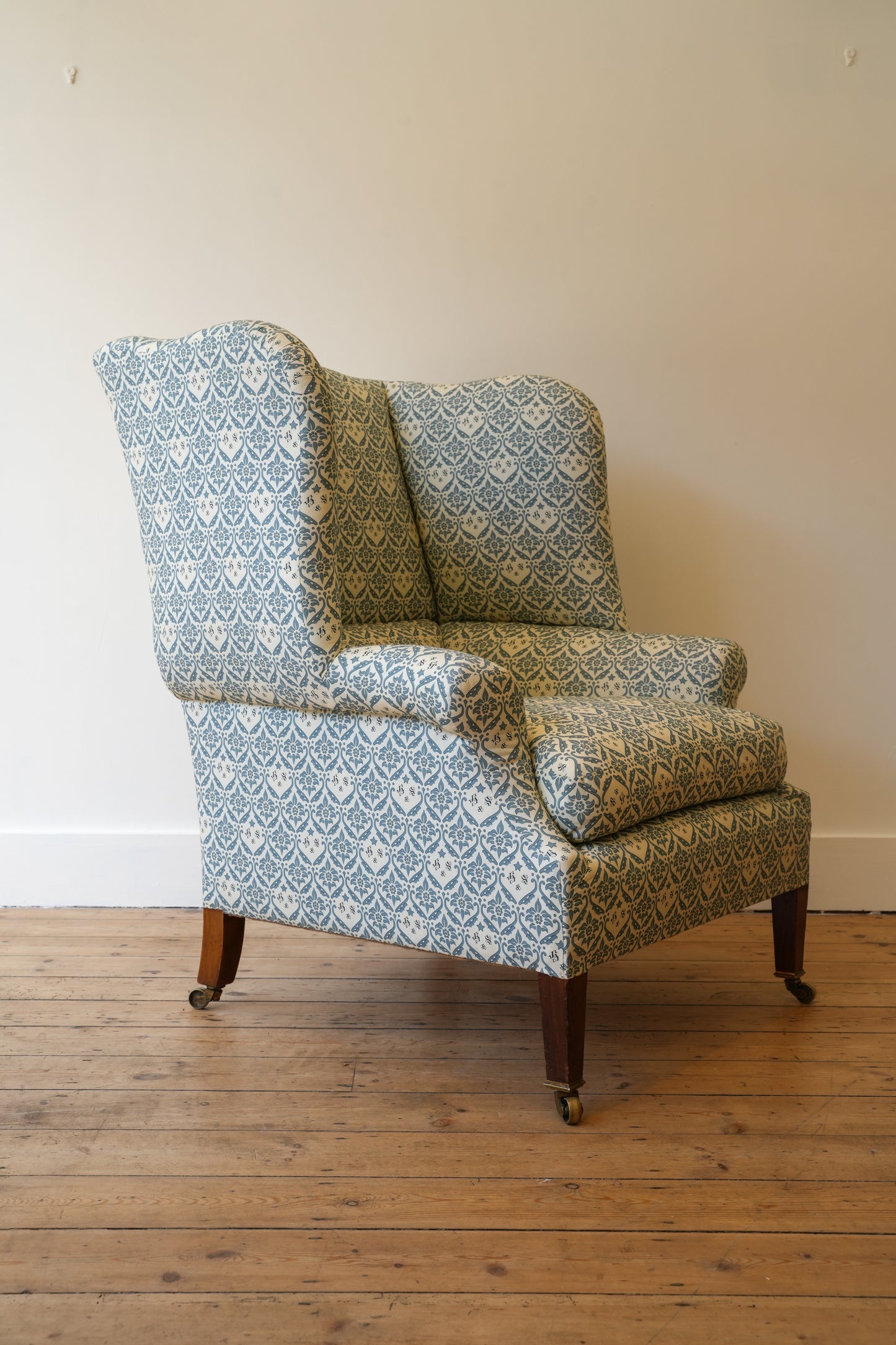A Howard & Sons Wingback Armchair.