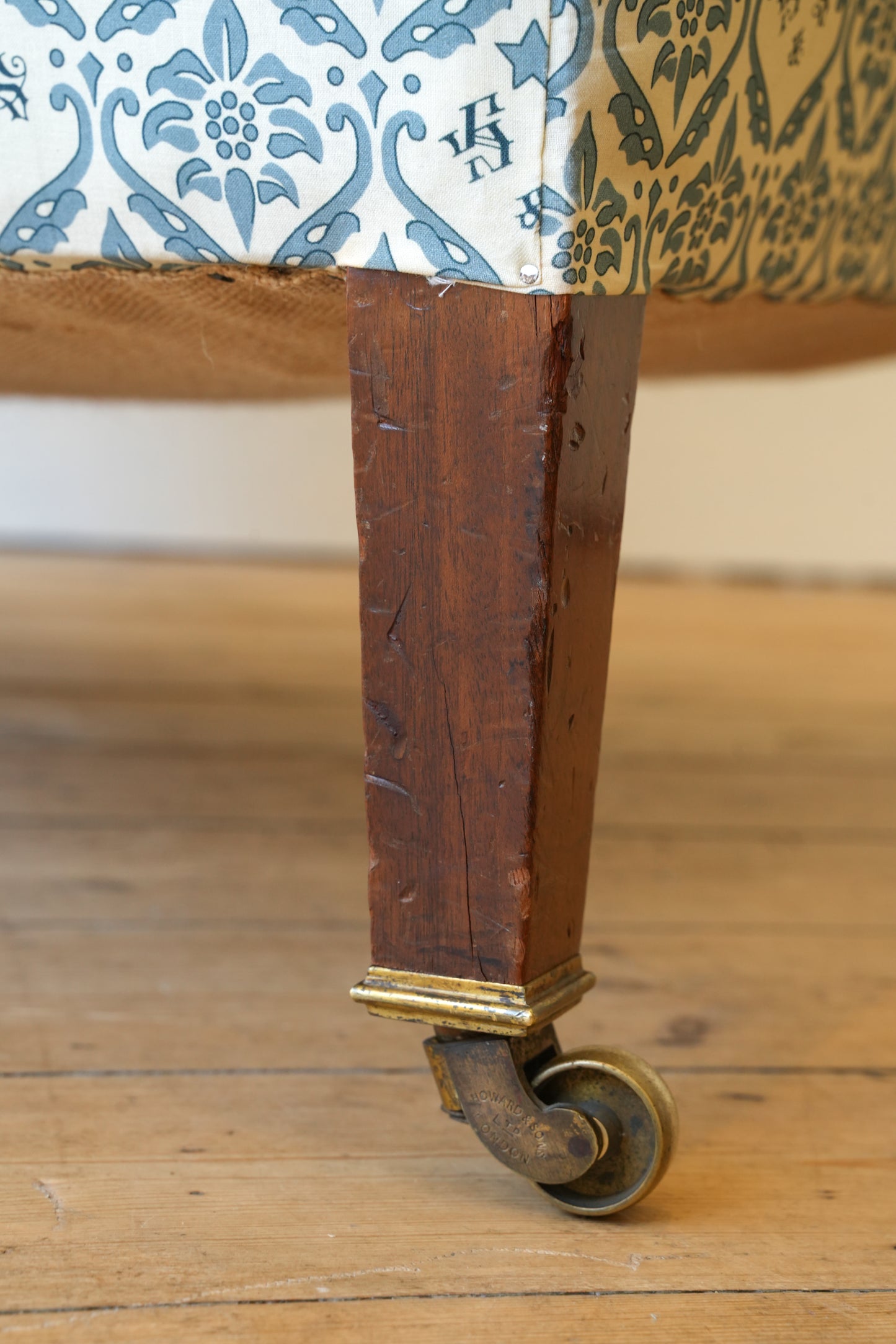 A Howard & Sons Wingback Armchair.