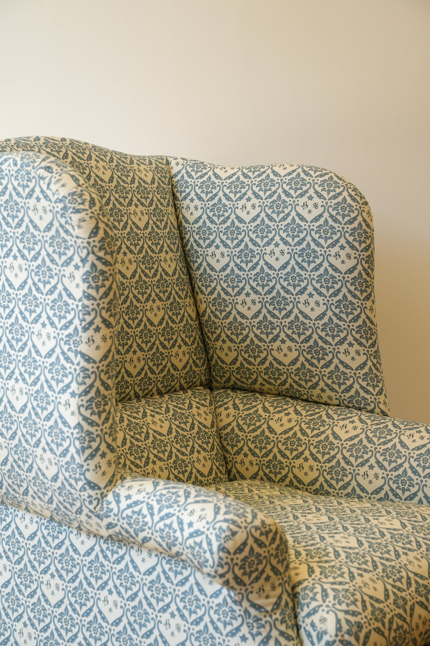 A Howard & Sons Wingback Armchair.