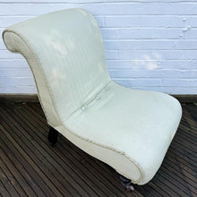 A late 19th century scrolled back slipper chair