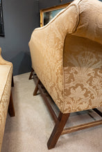 A matched pair of antique Camel back sofas