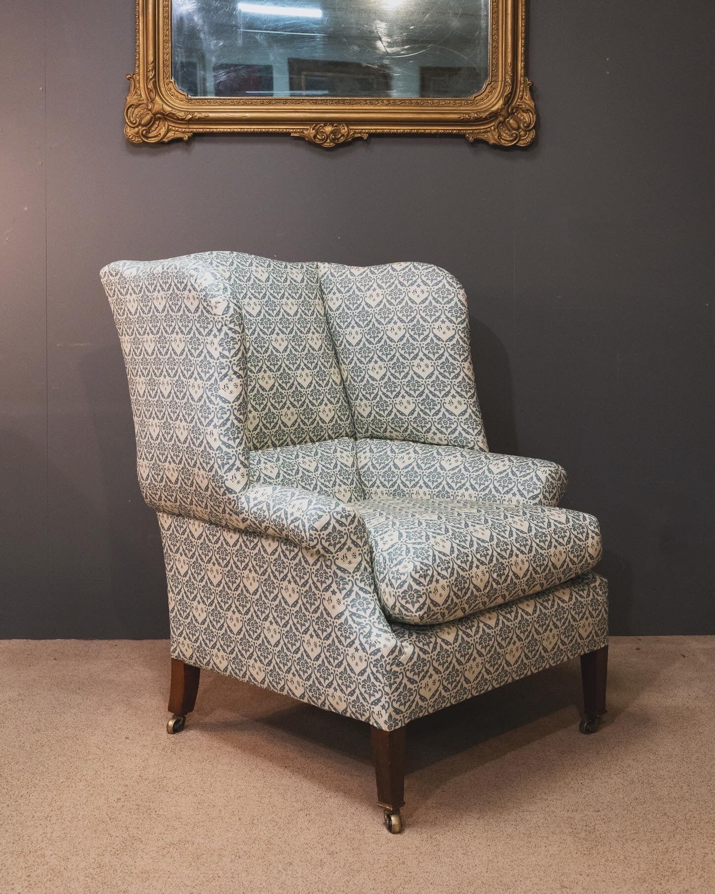 A Howard & Sons Wingback Armchair.