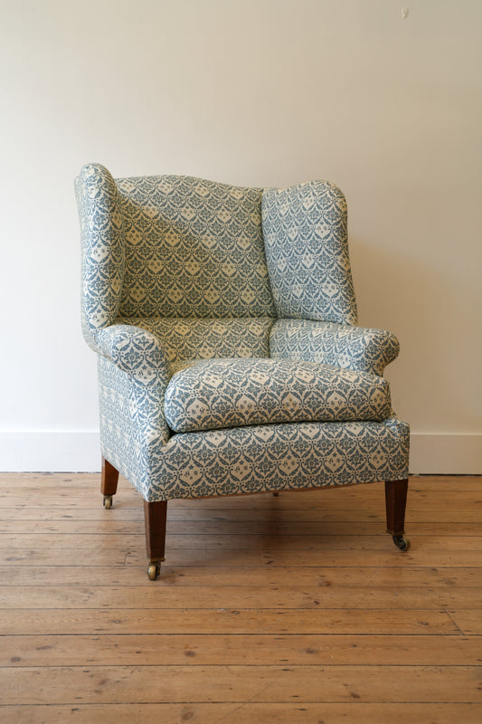 A Howard & Sons Wingback Armchair.