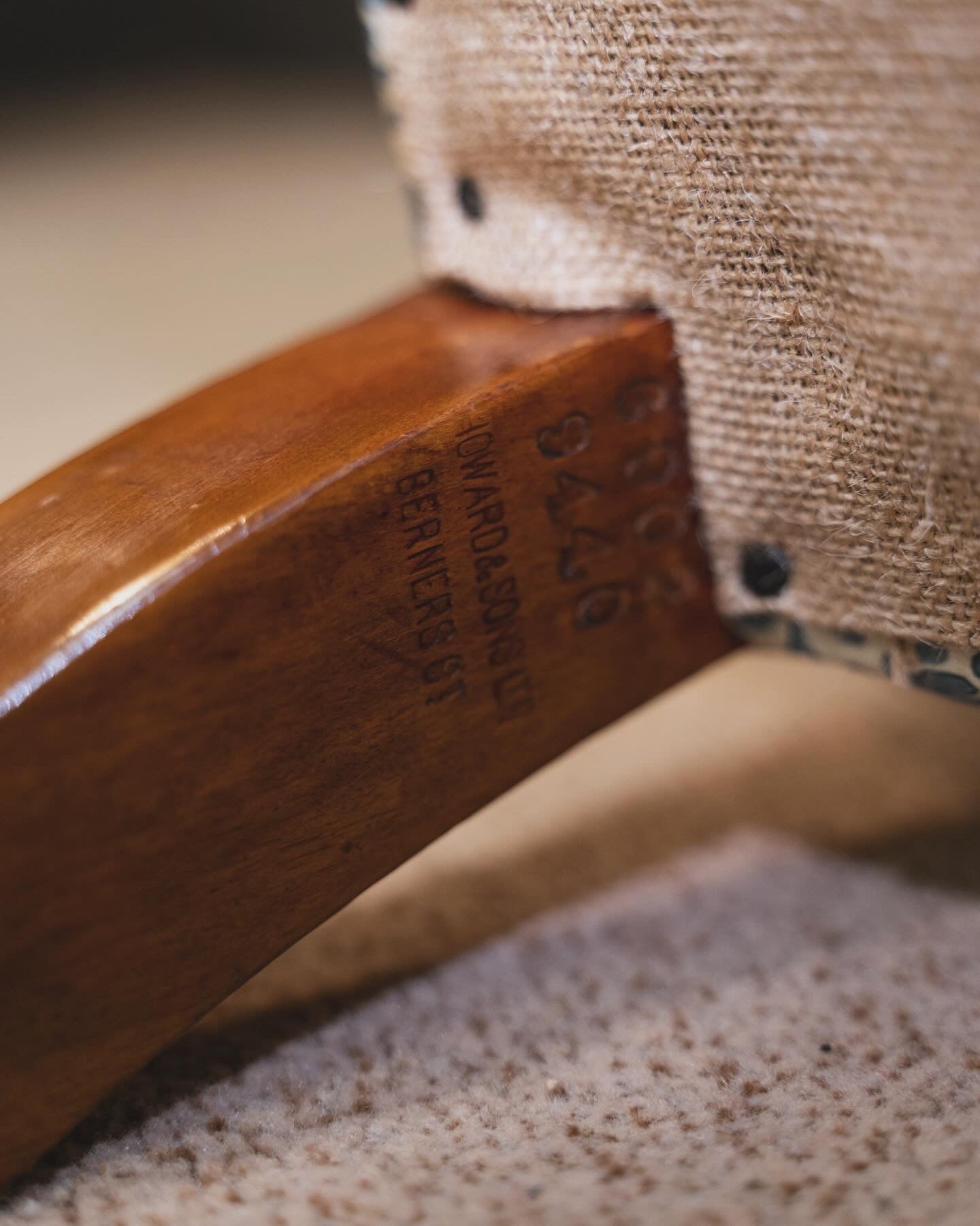 A Howard & Sons Wingback Armchair.