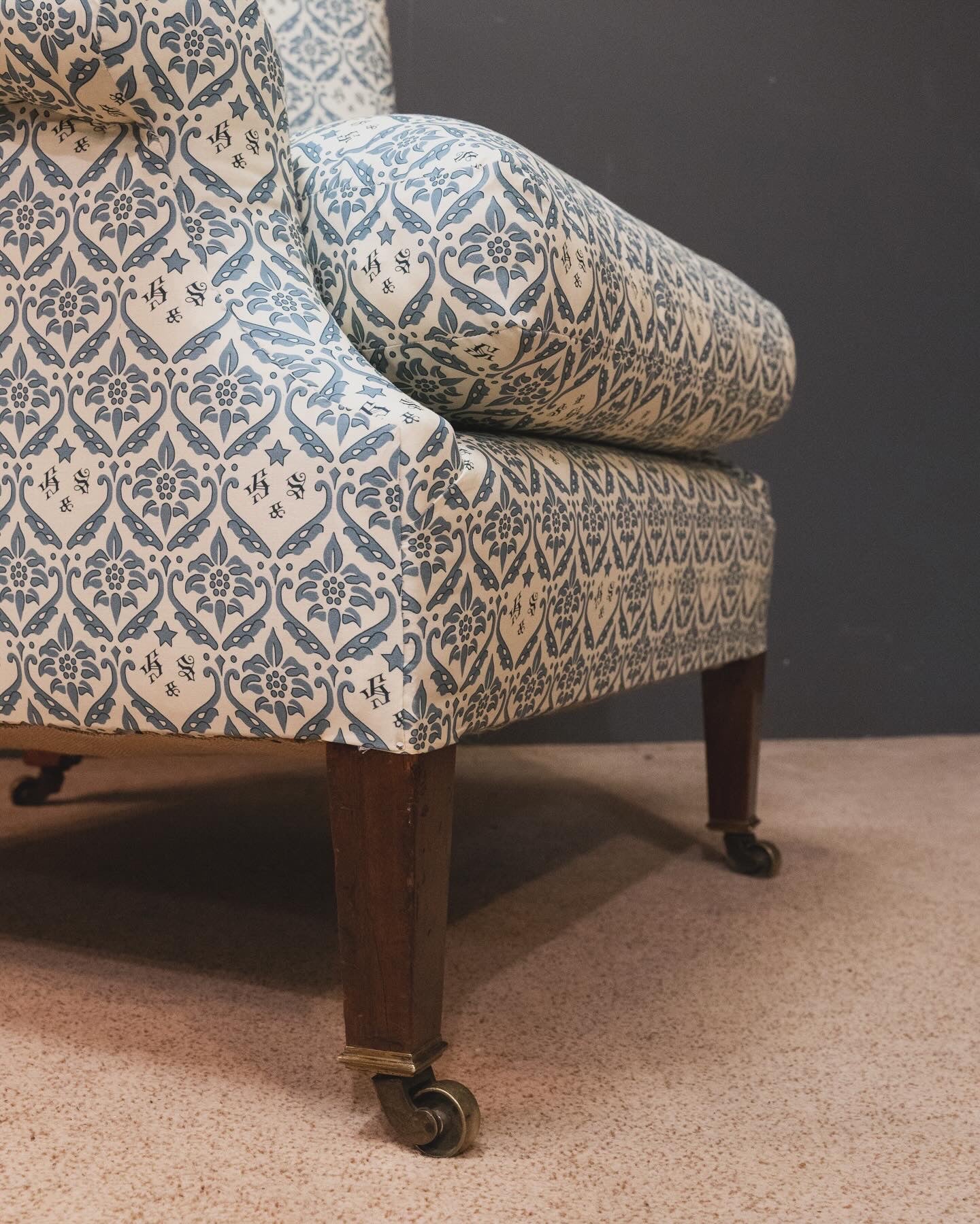 A Howard & Sons Wingback Armchair.