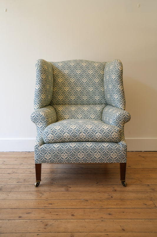 A Howard & Sons Wingback Armchair.