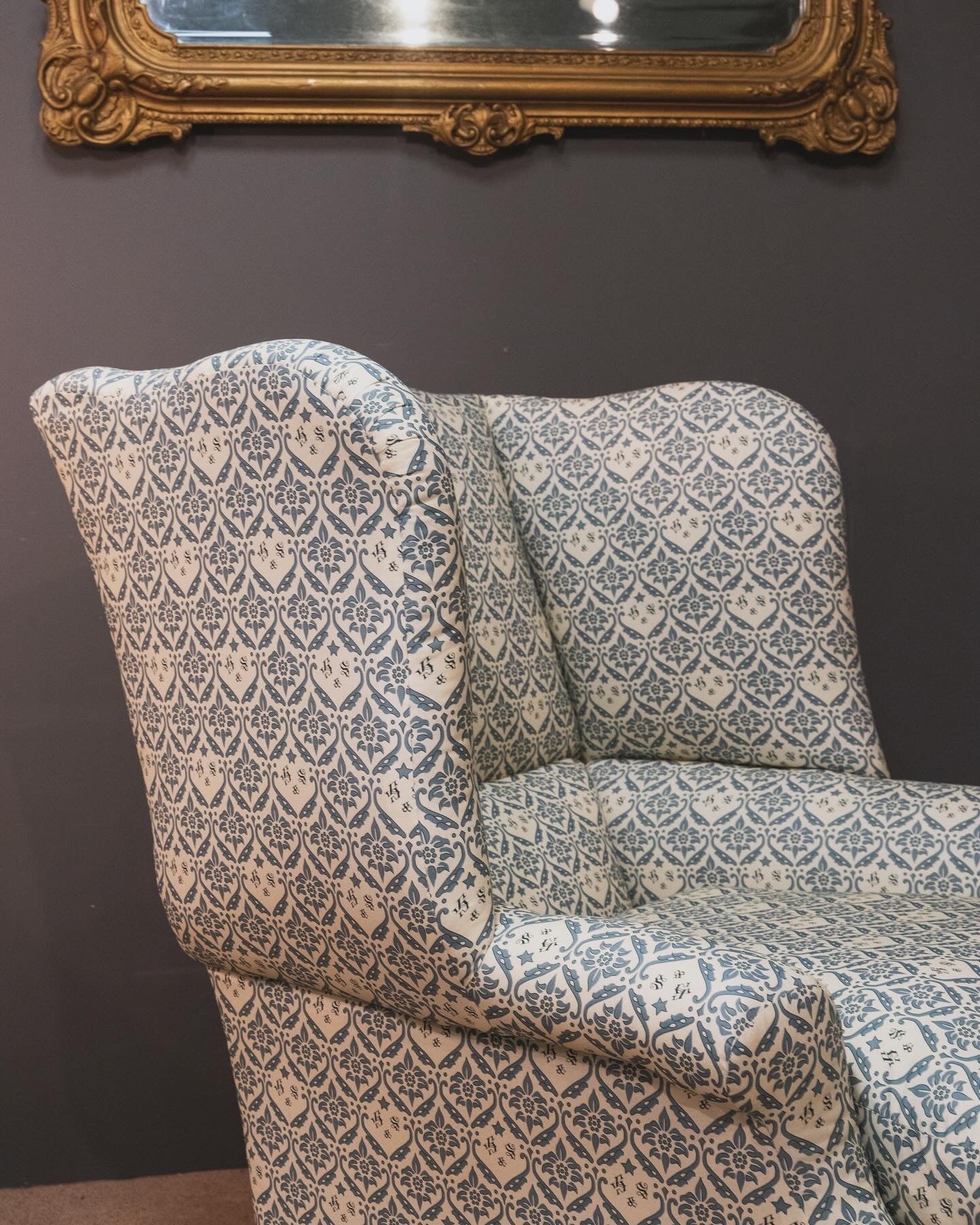 A Howard & Sons Wingback Armchair.