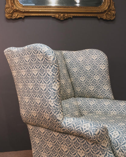 A Howard & Sons Wingback Armchair.
