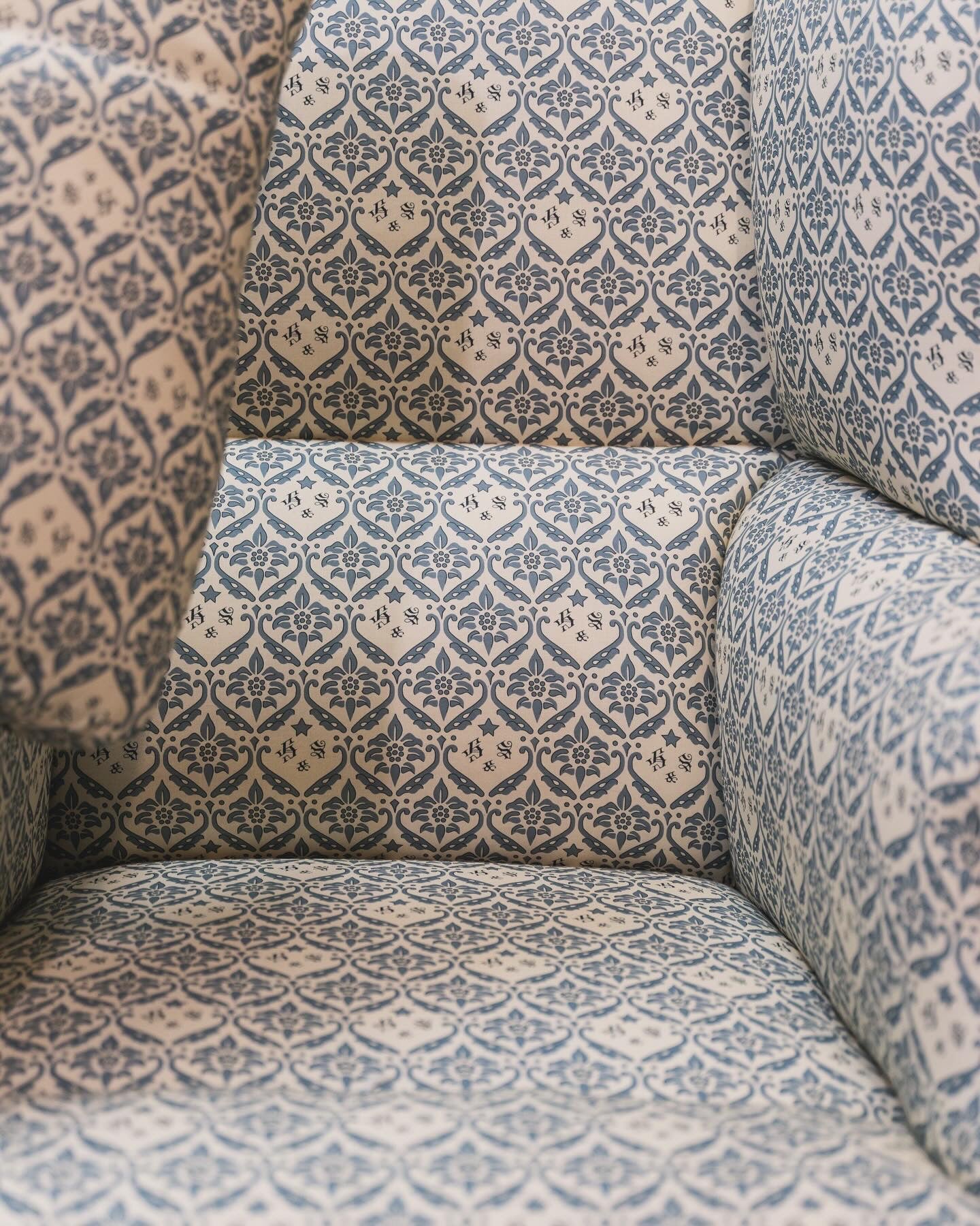 A Howard & Sons Wingback Armchair.