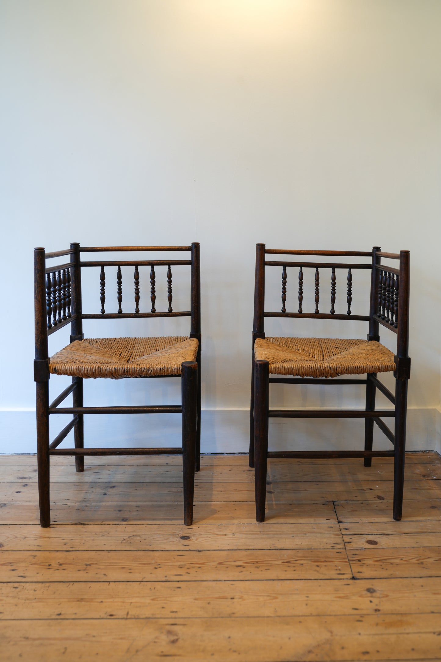 A pair of “Sussex” Corner Chairs.